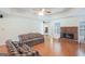 Spacious living room with tray ceiling, brick fireplace, and comfortable seating arrangement at 3533 Saddlebrook Dr, Loganville, GA 30052