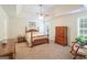 Spacious main bedroom boasts a tray ceiling, ceiling fan, and lots of natural light at 3533 Saddlebrook Dr, Loganville, GA 30052