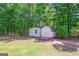 Two storage sheds provide ample space for your tools and hobbies, surrounded by beautiful trees at 3533 Saddlebrook Dr, Loganville, GA 30052