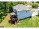 An aerial shows the rear of the home, a lawn and a deck with an outdoor dining table at 137 River Birch Dr, Carrollton, GA 30116