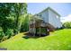 Expansive backyard with a covered wooden deck and lush landscaping enhances this home's outdoor appeal at 137 River Birch Dr, Carrollton, GA 30116