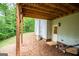 Backyard view with a covered deck, showing outdoor features and landscaping at 137 River Birch Dr, Carrollton, GA 30116