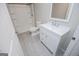 Bright bathroom featuring a white vanity, toilet, and a shower with a glass door at 137 River Birch Dr, Carrollton, GA 30116