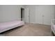 Bedroom featuring a neutral color scheme, twin beds, and a spacious closet at 137 River Birch Dr, Carrollton, GA 30116