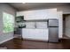 Modern kitchen with white cabinets, stainless steel appliances, and hardwood floors at 137 River Birch Dr, Carrollton, GA 30116