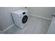 Bright laundry area featuring a modern washer/dryer and neutral tile floors for easy maintenance at 137 River Birch Dr, Carrollton, GA 30116