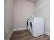 Functional laundry room equipped with a washer, dryer, and storage shelf at 137 River Birch Dr, Carrollton, GA 30116