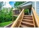 Elevated wooden deck with stairs, offering an outdoor dining area and a scenic view at 137 River Birch Dr, Carrollton, GA 30116