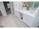 Bathroom featuring double vanity sinks, quartz countertops, tile floors with closet entrance at 137 River Birch Dr, Carrollton, GA 30116