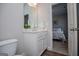 Bathroom view with white vanity, framed mirror, and view into bright bedroom at 137 River Birch Dr, Carrollton, GA 30116