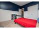 Bedroom with a navy accent wall, white wainscoting, and a large closet at 137 River Birch Dr, Carrollton, GA 30116