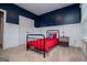 Bedroom with navy accent wall, white wainscoting, and large window for plenty of light at 137 River Birch Dr, Carrollton, GA 30116