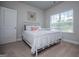Bright, neutral bedroom with large window, white trim, and soft carpet at 137 River Birch Dr, Carrollton, GA 30116