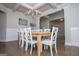 Elegant dining room features a wooden table, white chairs, and a stylish chandelier at 137 River Birch Dr, Carrollton, GA 30116
