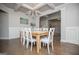 Elegant dining room features a wooden table, white chairs, and a stylish chandelier at 137 River Birch Dr, Carrollton, GA 30116