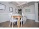 Charming dining room with a wooden table, white chairs, and decorative wall art at 137 River Birch Dr, Carrollton, GA 30116