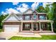 Charming two-story brick home with covered porch and well-manicured lawn at 137 River Birch Dr, Carrollton, GA 30116
