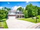 Charming two-story brick home with covered porch and well-manicured lawn at 137 River Birch Dr, Carrollton, GA 30116