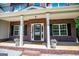 Charming covered front porch with brick accents and flower pots, offering a welcoming and inviting entrance at 137 River Birch Dr, Carrollton, GA 30116