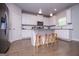 Well-equipped kitchen features an island, granite countertops, stainless steel appliances, and hardwood floors at 137 River Birch Dr, Carrollton, GA 30116