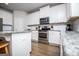 Beautiful kitchen with stainless steel appliances, granite countertops, and white cabinets at 137 River Birch Dr, Carrollton, GA 30116