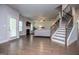 Spacious living room features hardwood floors, a fireplace, and staircase leading to upper floors at 137 River Birch Dr, Carrollton, GA 30116