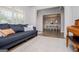 Stylish living room with a comfortable couch, rug, and an open view to the dining area at 137 River Birch Dr, Carrollton, GA 30116