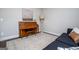 Comfortable living room featuring a piano, a blue sofa with decorative pillows, and an elegant rug at 137 River Birch Dr, Carrollton, GA 30116