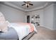 Carpeted main bedroom features a tray ceiling, neutral walls, and built-in shelving for organized storage at 137 River Birch Dr, Carrollton, GA 30116