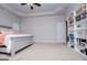 Spacious bedroom features a tray ceiling, neutral walls, and built-in shelving with carpeted floor at 137 River Birch Dr, Carrollton, GA 30116