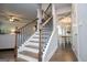 Staircase with hardwood steps and iron railing, leading up to an open dining room area at 137 River Birch Dr, Carrollton, GA 30116