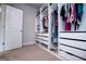 Large walk-in closet features custom shelving, drawers and hanging racks for optimal organization at 137 River Birch Dr, Carrollton, GA 30116