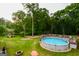 Large backyard with an above-ground pool and deck; perfect for entertaining at 855 Hood Rd, Fayetteville, GA 30214