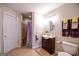 Well-lit bathroom with tiled shower, vanity, tile floor, and modern fixtures at 855 Hood Rd, Fayetteville, GA 30214