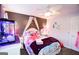 Charming bedroom with a unique mermaid theme and a well-lit fan and playful decor at 855 Hood Rd, Fayetteville, GA 30214