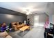 Large bonus room with neutral carpeting, a comfy sofa, and an exercise corner with lots of room for activities at 855 Hood Rd, Fayetteville, GA 30214