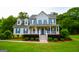 Inviting two-story home with blue shutters, manicured landscaping, and a welcoming front porch at 855 Hood Rd, Fayetteville, GA 30214