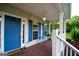 Cozy front porch with blue door, blue shutters, and outdoor seating at 855 Hood Rd, Fayetteville, GA 30214