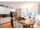 Open kitchen featuring an island with granite countertops, stainless steel appliances, and hardwood floors at 855 Hood Rd, Fayetteville, GA 30214