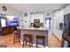 Kitchen view with a breakfast bar, stainless steel appliances, and hardwood flooring at 855 Hood Rd, Fayetteville, GA 30214
