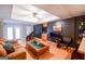 Comfortable living room with hardwood floor, dark accent wall, fireplace, and a ceiling fan at 855 Hood Rd, Fayetteville, GA 30214
