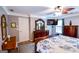 Bright main bedroom features a king bed, dark wood furniture, crown molding, and a wall-mounted TV at 855 Hood Rd, Fayetteville, GA 30214