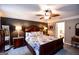 Main bedroom boasting a king bed, dark wood furniture, bedside lamps, and an en-suite bathroom with a tub at 855 Hood Rd, Fayetteville, GA 30214