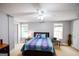 Bedroom with a colorful quilt, ceiling fan, bedside tables, and natural light at 855 Hood Rd, Fayetteville, GA 30214