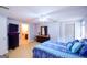 Large bedroom with dark furniture, colorful comforter and in-suite bathroom at 855 Hood Rd, Fayetteville, GA 30214
