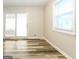 Sunny living area featuring wood-look floors and access to the backyard at 338 Mount Zion Rd, Hapeville, GA 30354
