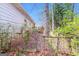 Backyard exterior featuring a chain-link fence, leafy foliage, and access to a wooden deck at 8005 Big Rock Dr, Douglasville, GA 30134