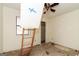Unfinished bedroom features natural light from a window, ceiling fan, and ladder to the attic at 8005 Big Rock Dr, Douglasville, GA 30134
