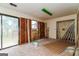 View of an unfinished interior space with exposed studs, sliding doors, and a window at 8005 Big Rock Dr, Douglasville, GA 30134