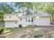 Rear exterior of home featuring a neutral color palette, mature trees, and bay window at 2730 Pine Log Way, Buford, GA 30519
